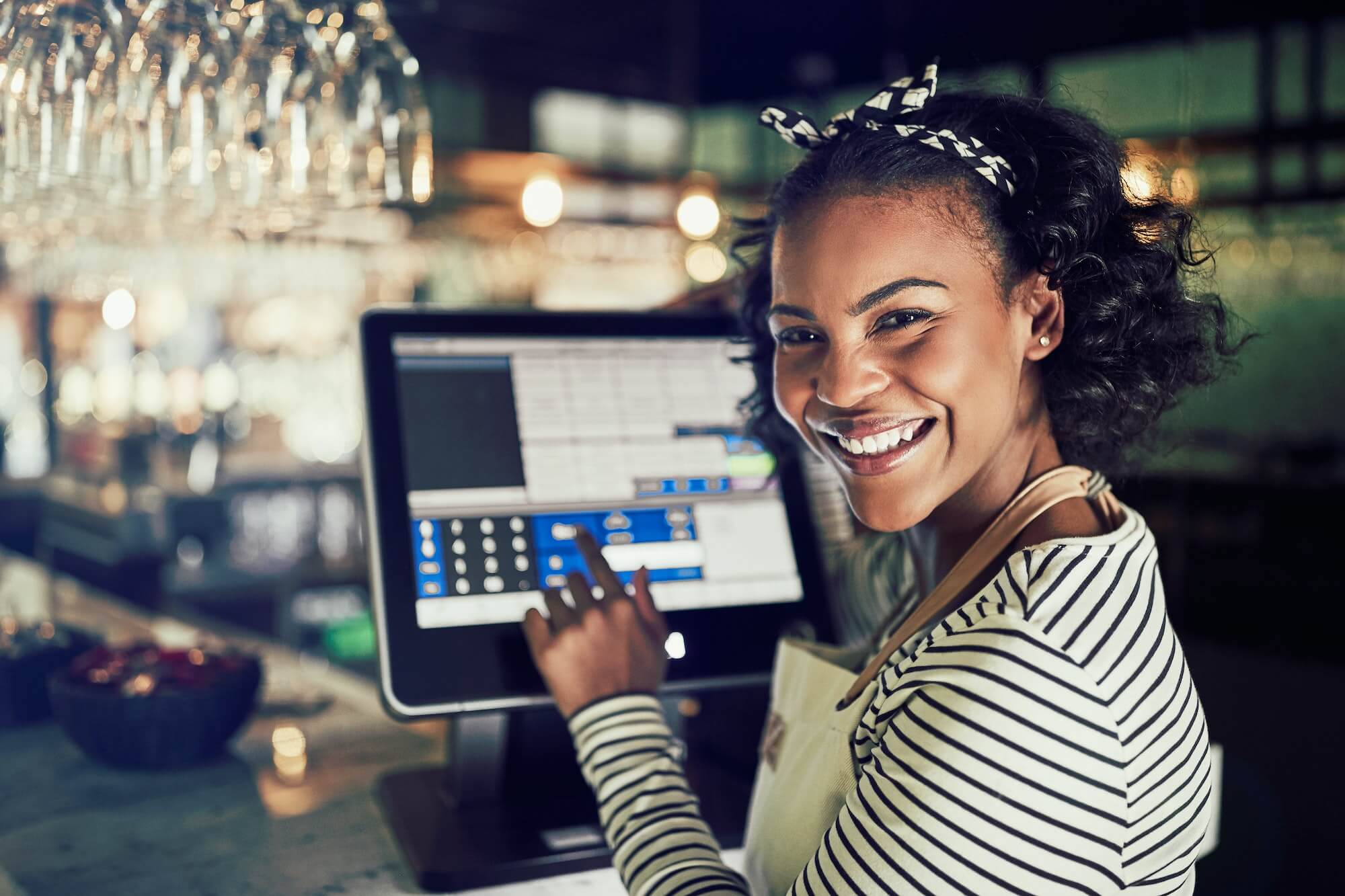 smiling-african-waitress-using-a-restaurant-point-of-sale-terminal-1.jpg